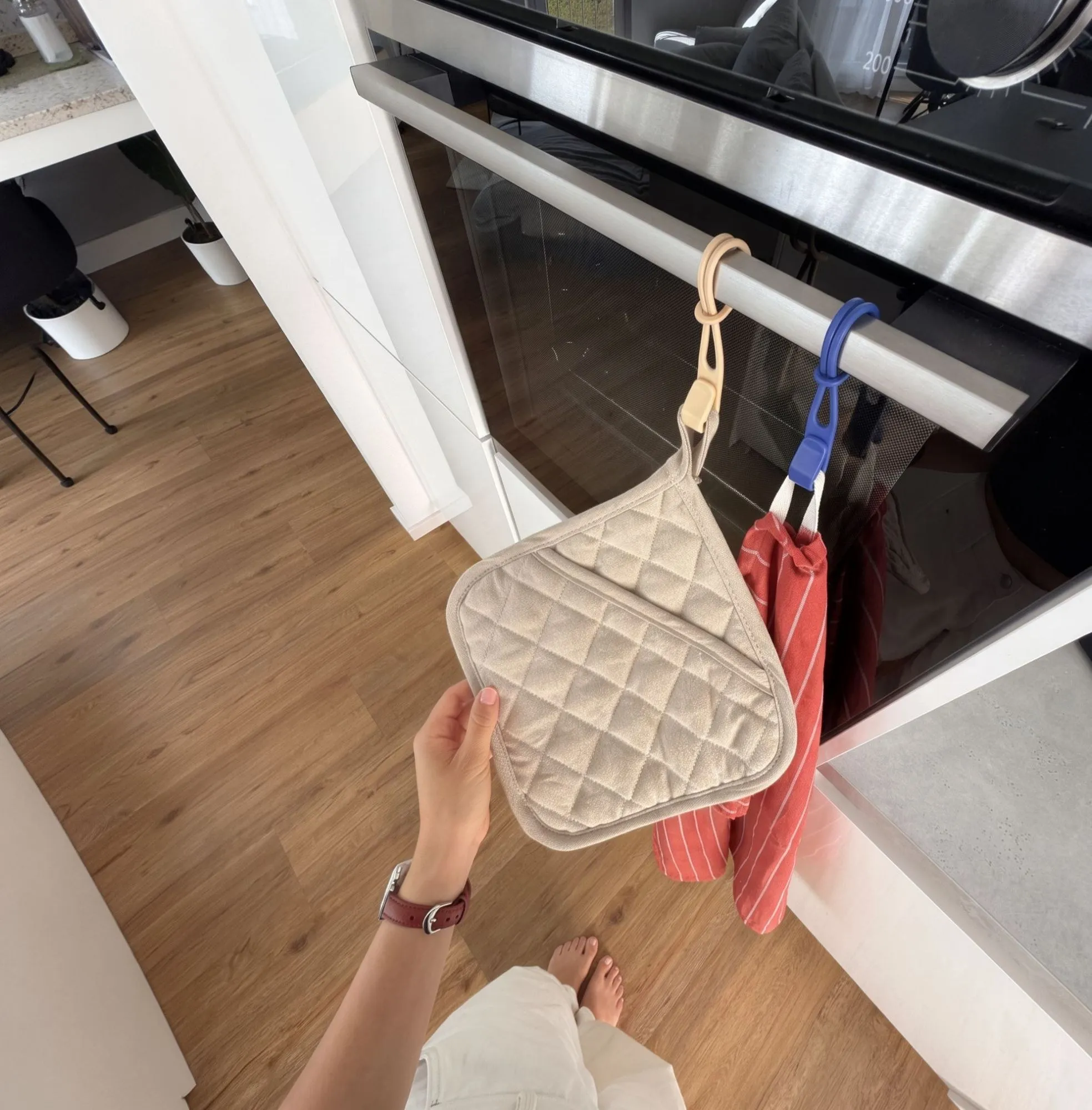 Two Stowey hooks holding an oven cloth and a tea towel on an oven handle