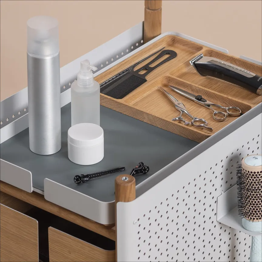 Wooden tray of the trolley with combs, scissors and bottles